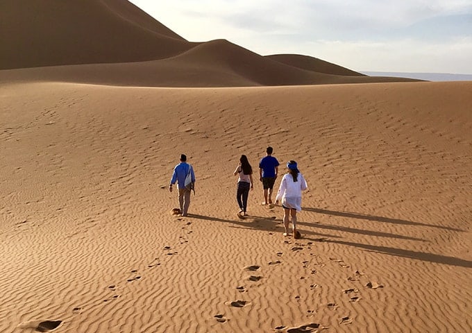 Walking up dunes near the camp